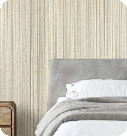 a bedroom with textured beige striped wallpaper